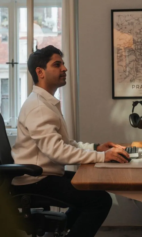 Faizur working at his desk